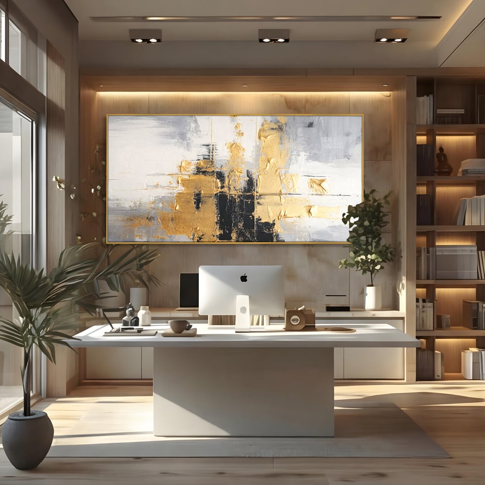 Tablou canvas cu pictura abstracta cu auriu si negru, in rama de aluminiu auriu, pe perete intr-un birou